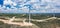 Wind turbines in rural landscape and stunning cloudy sky at the background. Environmentally friendly production of electrical