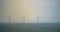 Wind turbines at sea with the Oresund bridge in the background