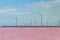 Wind turbines on a shore of pink salty Syvash lake in Kherson region, Ukraine. Renewable energy