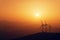 Wind turbines silhouette on mountain at sunset