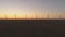 Wind turbines silhouettes working against sunset sky at the Black Sea coast