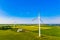 Wind turbines in summer fields, colorful aerial landscape. Alternative energy concept