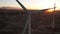 Wind turbines at sunset. Renewable energy, environment friendly concept. Wind Power Turbines Generating Clean Renewable