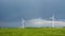 Wind turbines under a partly cloudy sky