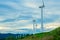 Wind turbines. Wind generators. Wind turbine generators. Alternative energy. Windmills over dramatic cloudy sky. Industrial