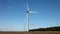 Wind turbines windmills generating green energy in a field of sunflowers
