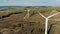 Wind turbines working on a big field. Green energy, renewable energy concept.