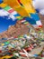 Wind wavering Buddhist Tibetan Chinese prayer flags with Sanskrit calligraphy written decorating mountain valley in Tibet, China