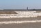 Wind Whipped Waves and Tiny Surfers Near Lighthouse