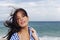 Wind: woman with tousled hair at the sea