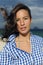 Wind: woman with tousled hair at the sea