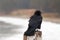 Windblown American crow Corvus brachyrhynchos perched on San Simeon pier on the central California coast - USA