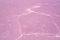 Windblown salt patterns of a pink lake.