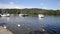 Windermere Lake District from Bowness with boats and ducks in summertime