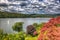 Windermere Lake District England uk with sailing boat with sail and trees coloured red