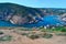 winding blue bay with ships and boats in water at piers among houses of town balaclava near rocks