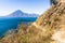 Winding dirt clifftop footpath, lake view & volcano, Lake Atitlan, Guatemala