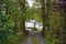 A winding drive leads past the trees and lake to a beautiful white converted mill