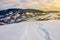 Winding foot path through snowy slope in mountains