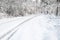 Winding forest road covered in snow