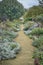 A winding garden path through flower borders