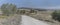 winding gravel dirt road in hilly countryside, near Scansano, Italy