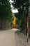 Winding gravel road and snow plow stake in the woods in autumn