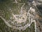 A winding mountain serpentine asphalt road. Top down aerial view