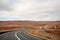 Winding open empty road surrounded by farms and fields in Outback Australia. Road trip travel