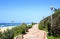 Winding Pedestrian Walkway With Beach And Ocean Backdrop