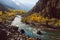 Winding river flowing along valley in Hindu Kush mountain range. Autumn season in Pakistan