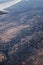 Winding river water crossing brown fields landscape on Spain view from an airplane