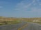 Winding road along plains and valleys of Wyoming