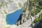 winding road down the steep slope of the mountain to the transparent deep blue karst lake in Imotski