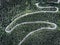 Winding road in the forest seen from above