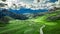 Winding road in Passo Giau and green Dolomites, aerial view