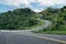 Winding road shaped like 3 on top of mountain in tropical rainforest at Nan province