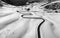 A winding road in the snow in Passo Giau, high alpine pass near Cortina d`Ampezzo, Dolomites, Italy