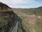 Winding road stretching across a mountainous landscape, lined with lush green foliage