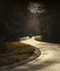 Winding rual road with car inside colorful autumn forest