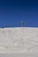 Winding snowboard trace and chairlift shadow on white snow