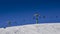 Winding snowboard trace and chairlift shadow on white snow