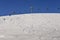 Winding snowboard trace and chairlift shadow on white snow