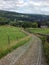 Winding stone cobbled lane running downhill in yorkshire landscape