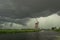 Windmill against a green sky below the base of a severe thunderstorm in The Netherlands.