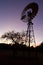 Windmill against sunset sky