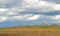 Windmill on a California hillside under a cloud filled sky