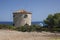 Windmill, Cape Skinari, Zakynthos - September 27, 2021: Beautiful traditional greece windmill on the rock up coastline