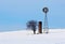 Windmill, Cistern and Tree in snowy field