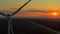 Windmill close-up, wind power plant at sunset from above, beautiful sky